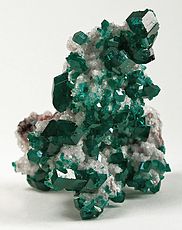Dioptase crystals on calcite, a classic Tsumeb specimen. Size: 8.2 x 5.8 x 5.5 cm