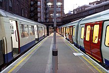 A southbound A60 stock Metropolitan line train stands on Platform 3. A terminating S8 stock train is on Platform 4 on the right.