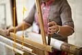 Pineapple-plant fiber and silk threads being woven in a traditional loom.