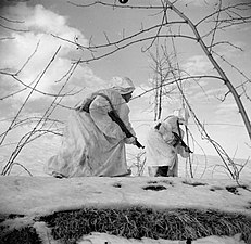 Indian troops proceed through snow near Castel Bolognese