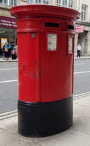 A double aperture pillar box in Fleet Street, London. This pillar box was made between 1887 and 1901, as it bears the Royal cypher 'VR' for Queen Victoria.
