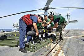 Flickr - Official U.S. Navy Imagery - Sailor lower a Hellfire missile into it's case..jpg