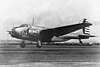 A left view of a mid-wing, twin-engine, taildragger monoplane