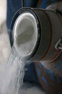 A transparant liquid, with visible evaporation, being poured into a beaker