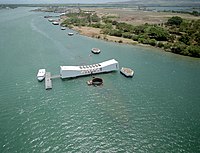 White Arizona memorial with downward sloped top and American flag