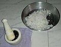 Grated coconut (soy) and palm jaggery (mâddâcheñ godd) in mortar and pestle