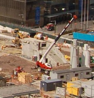 A few flights of concrete stairs seen from a distance, magnified, in the middle of a construction site.