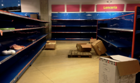 Shortages leave shelves empty in this Venezuelan store.