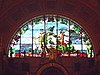 North lunette stained-glass window of coat of arms of Liverpool, flanked by Neptune and a triton, (1883–84) by Forrest and Sons of Liverpool