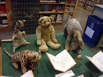 The original Winnie-the-Pooh toy animals, with Tigger on the bottom-left.