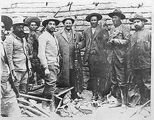 Carl von Hoffman and Pancho Villa in center, 8 men standing wearing wide brimmed hats