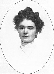 B&W portrait photograph of a young woman with her hair in an up-do.