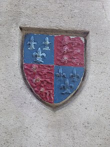 The school's arms on a monument in the town