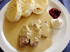 Svíčková: Sirloin steak with root vegetable and cream gravy, dumplings, and cranberries