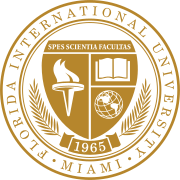 A gold and white seal. On the outer roundel are the words Florida International University and Miami, set in a serif. A shield topped with the motto "Spes Scientia Facultas" dominates the middle. Beneath are a torch, book, and globe. A scroll beneath the shield contains the year of foundation, 1968, and a laurel.