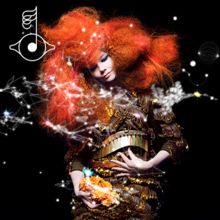 The background is Black and Björk is wearing a brown, swirly, earthy dress and a little harp looking is above on her stomach and dress. holding the ore that is a color yellow uneffortly but she tries not to break it but she is smiling. Her hair have a color of a Orange and Red. Head tilted. and a stars is floating around that has a line connecting with others.