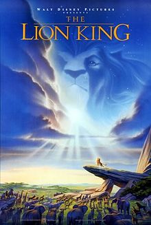 In an African savannah, several ainimals stare at a lion atap a heich rock. A lion's heid can be seen in the cloods abuin. Atap the image is the text "Walt Disney Pictures presents The Lion King".