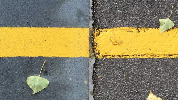 Yellow line of paint on the ground