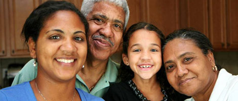 A family of four smiling.