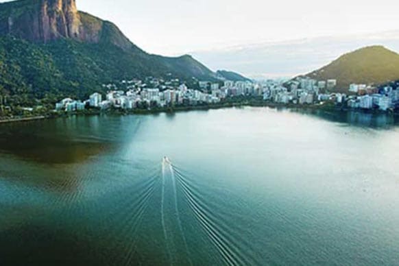 Coastal and mountains region of Brasil with dwellings surrounded by water