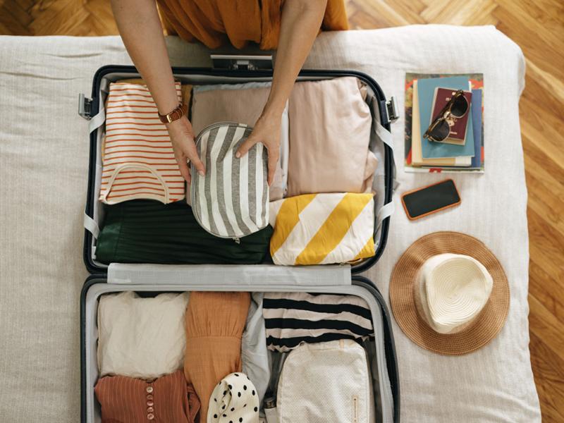 Person packing up a suitcase