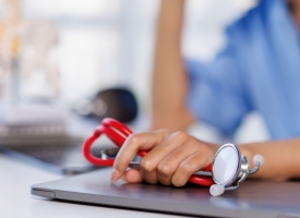 Image of doctor with stethoscope and laptop