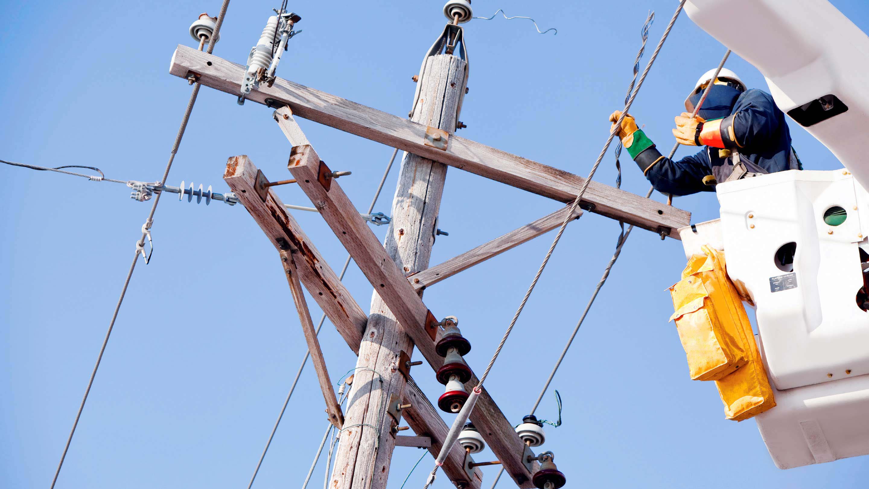 Construction worker fixing electrical wiring