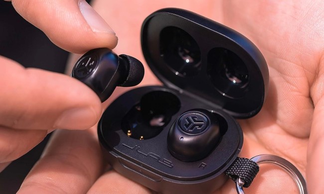 The JLab JBuds Mini in a person's hands.