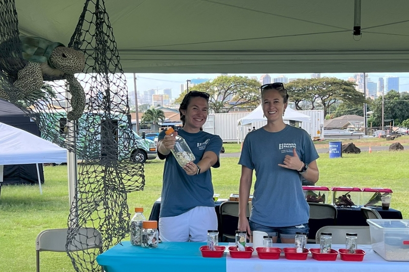 Two CMDR members manning a booth at a public outreach event.