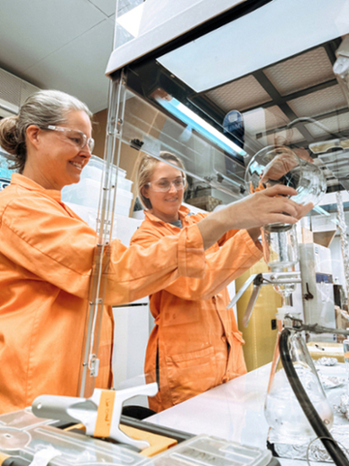 Two scientists filtering water samples in the CMDR laboratory. 