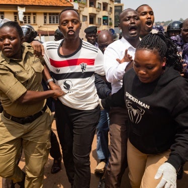 Members of the Uganda Police force arrest protesters marching to parliament during a planned anti-corruption demonstration in Kampala on July 23, 2024. 