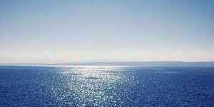 Sparkling sea under a clear blue sky.