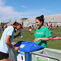 sustainNU volunteer educating about waste