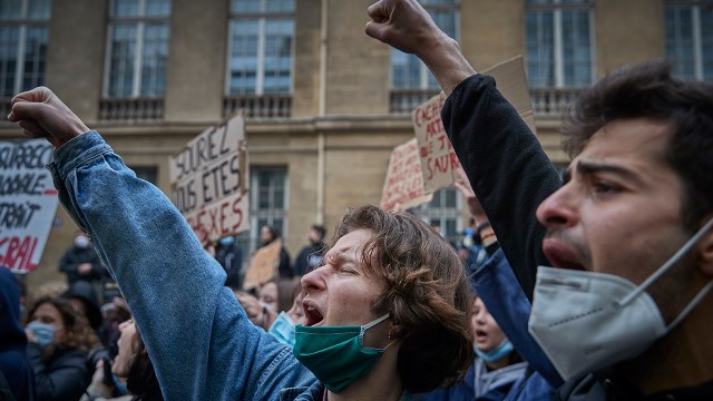 Protesters chant and demonstrate outside the French Senate in Paris, opposing a new law they say would consolidate police power and restrict civil liberties, on March 16, 2021. (Kiran Ridley/Getty Images)