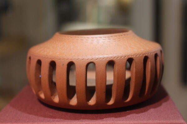 Pottery incense cup with slots.