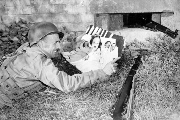 Herbert Bachant looking at his wife and new born triplets