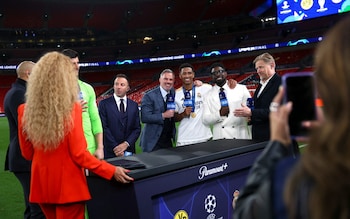 Real Madrid's Jude Bellingham with TV pundits and former players Jamie Carragher, Micah Richards and Peter Schmeichel after the match