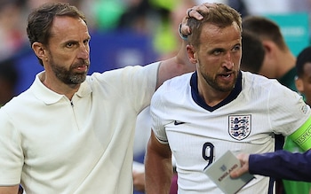 Harry Kane is patted on the head by England's head coach Gareth Southgate after falling on the side of the pitch during the Euro 2024 quarter-final against Switzerland 