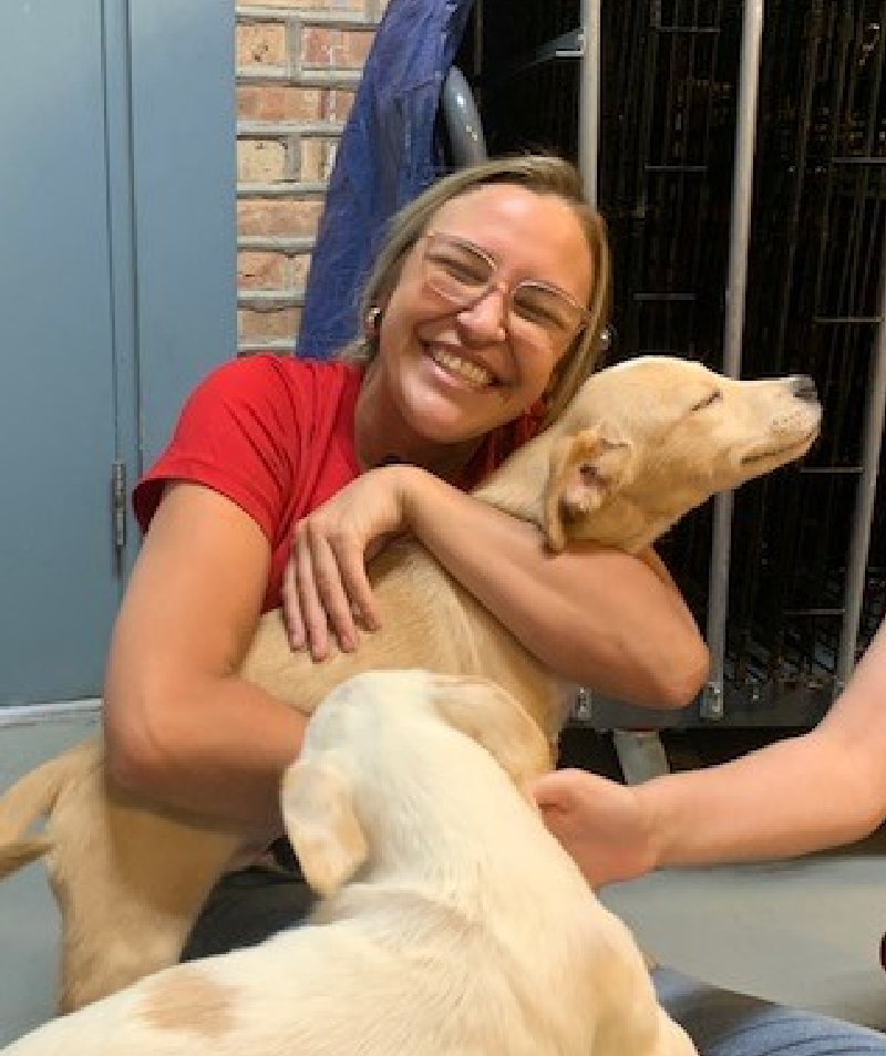 UL Solutions employee hugging a dog