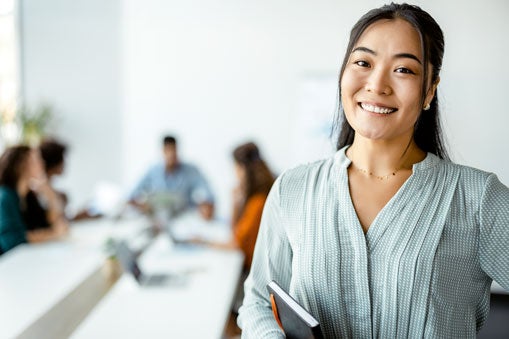 Person holding a notebook about to attend a meeting