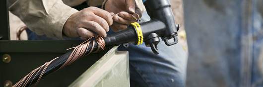 Worker installing medium voltage cable.