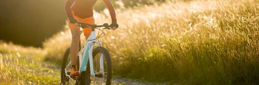 One woman on electric mountain bike in summer.