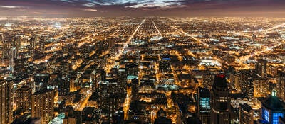 Cityscape at night with many lights from homes, businesses, roads