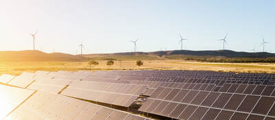 Sunrise on a solar and wind farm