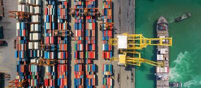 Overhead view of shipping containers being moved from a ship