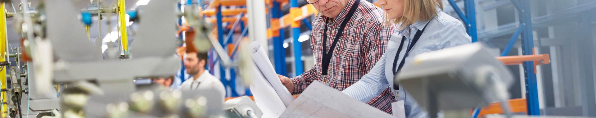 Supervisor and engineer discussing plans in fiber optics factory