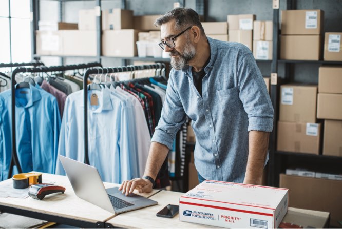 Small Business owner preparing to ship a Priority Mail package.