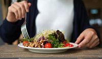 Person with big plate of salad