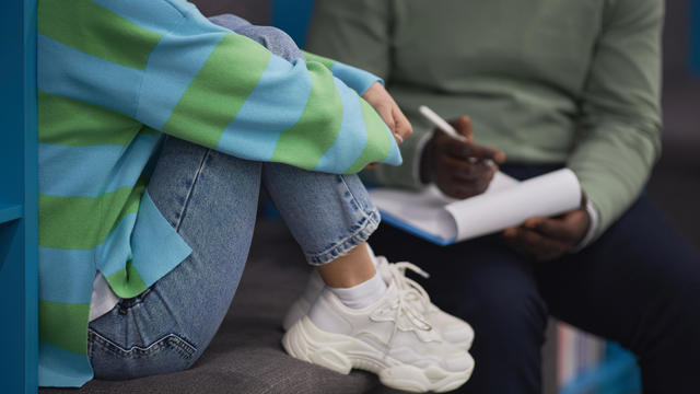 Teenage girl talking to therapist in counseling session 