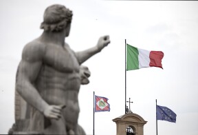 The Italian national flag, center, flies on top of the Quirinale Palace in Rome, Italy.